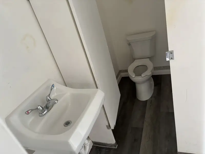 Commercial restroom with wall-hung sink and toilet installed