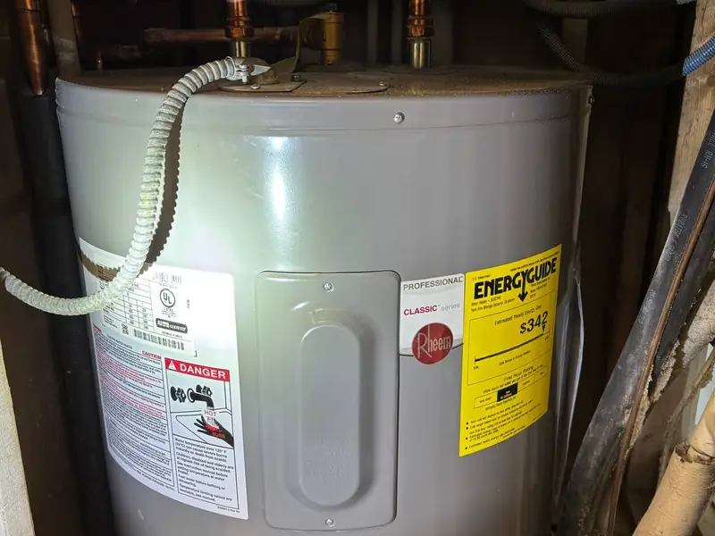 New lowboy water heater installed in a closet with drain pan